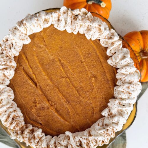 Overhead view of a healthier pumpkin pie with homemade whipped cream on top